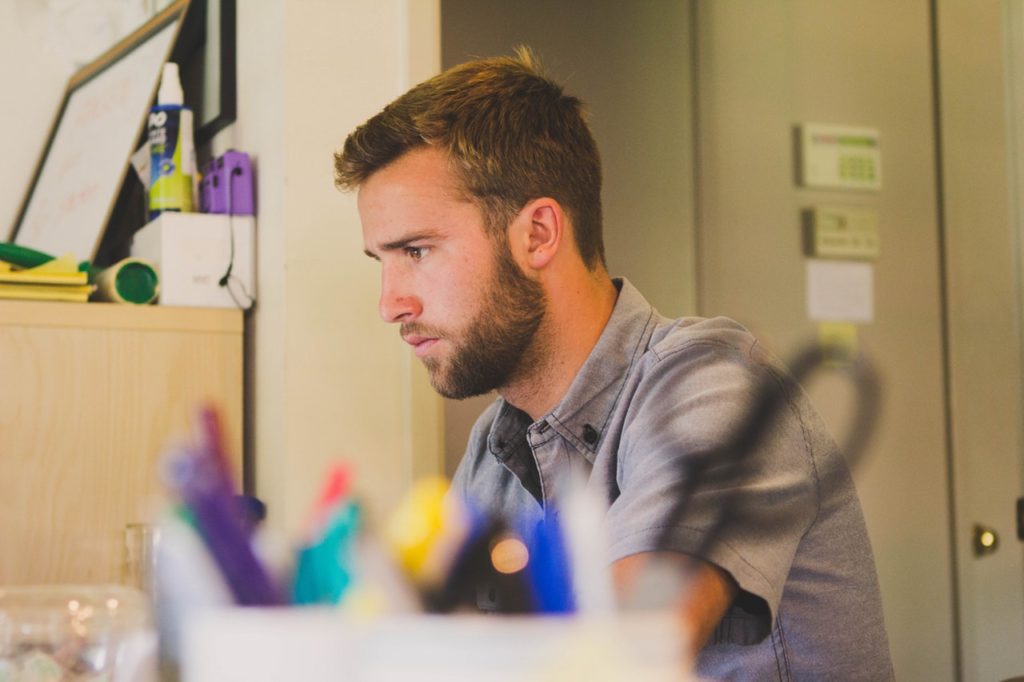 a guy is studying at the desk