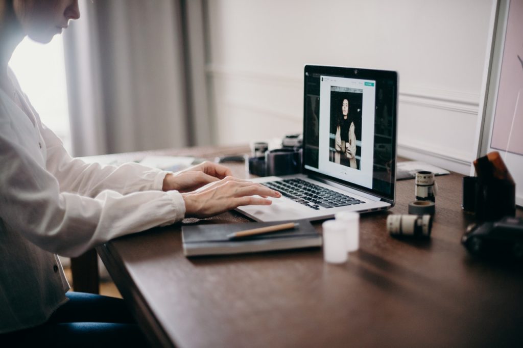 a girl is sitting in front of her laptop