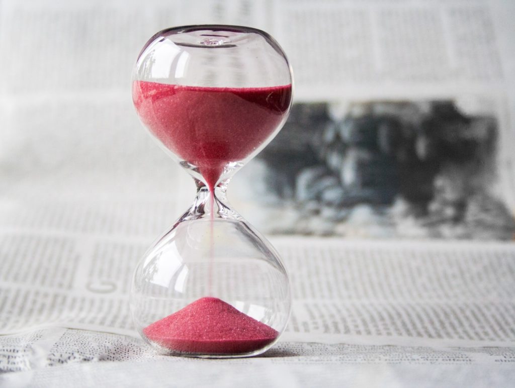 an hourglass with red sand
